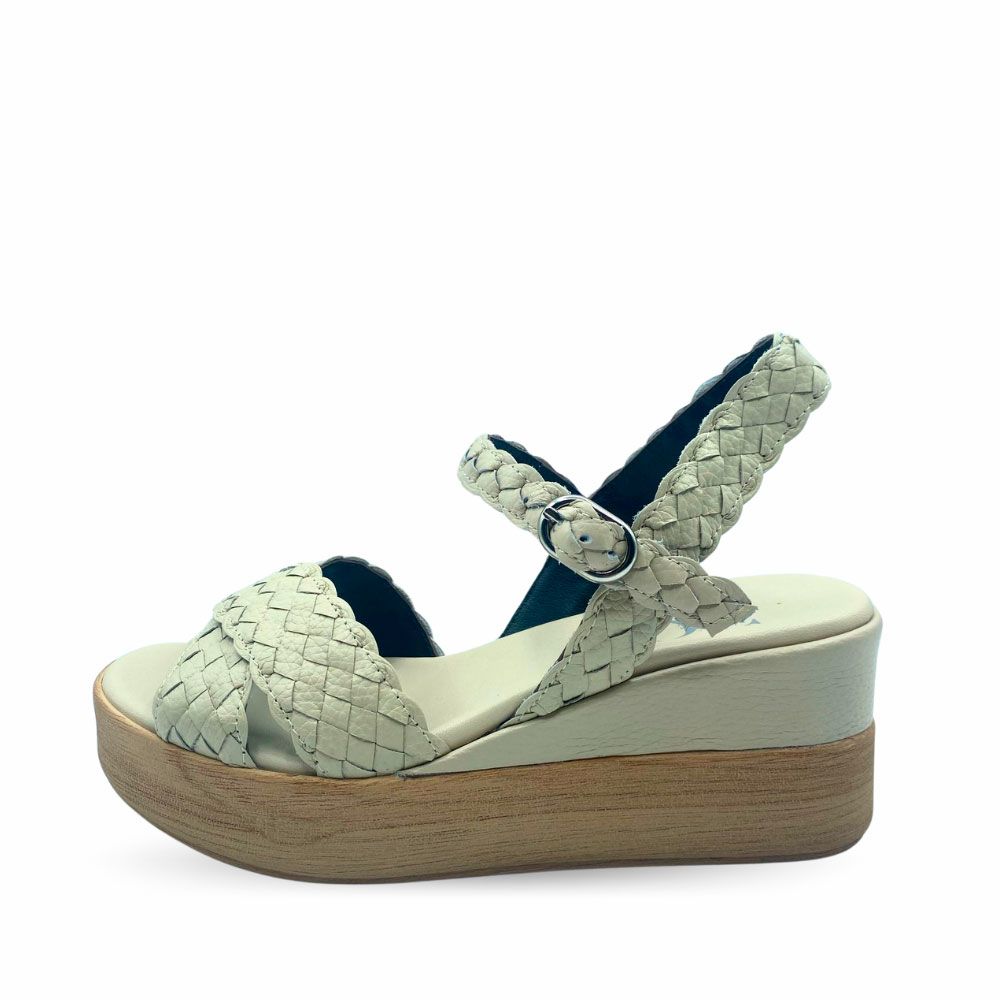 Sandalias de piel trenzada color beige, cierre con hebilla y suela de plataforma con cuña.