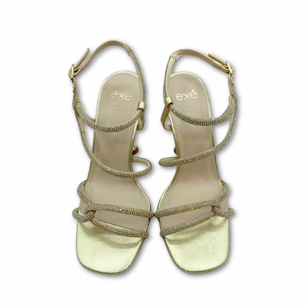 Sandalias doradas con cordones brillos y tacón de copa de Exé.